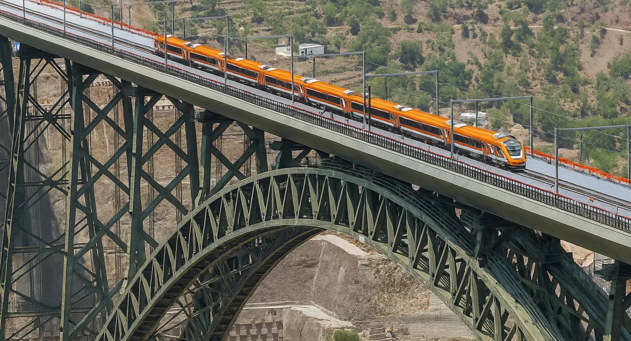 a vande bharat train crossing the newly inaugurated chenab bridge - the world highest arch rail bridge in india